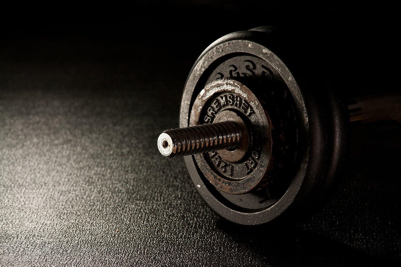 Vintage dumbbell on a dark surface